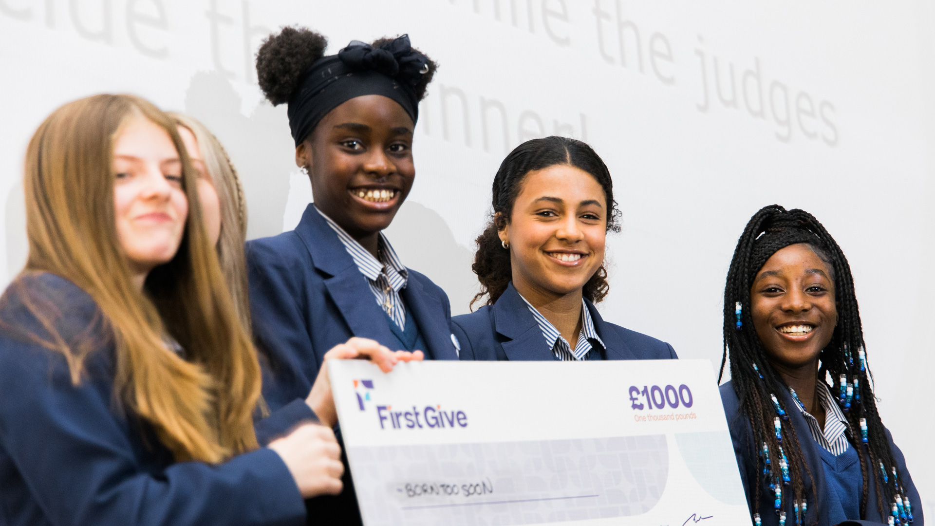 Group of girls from school with First Give cheque